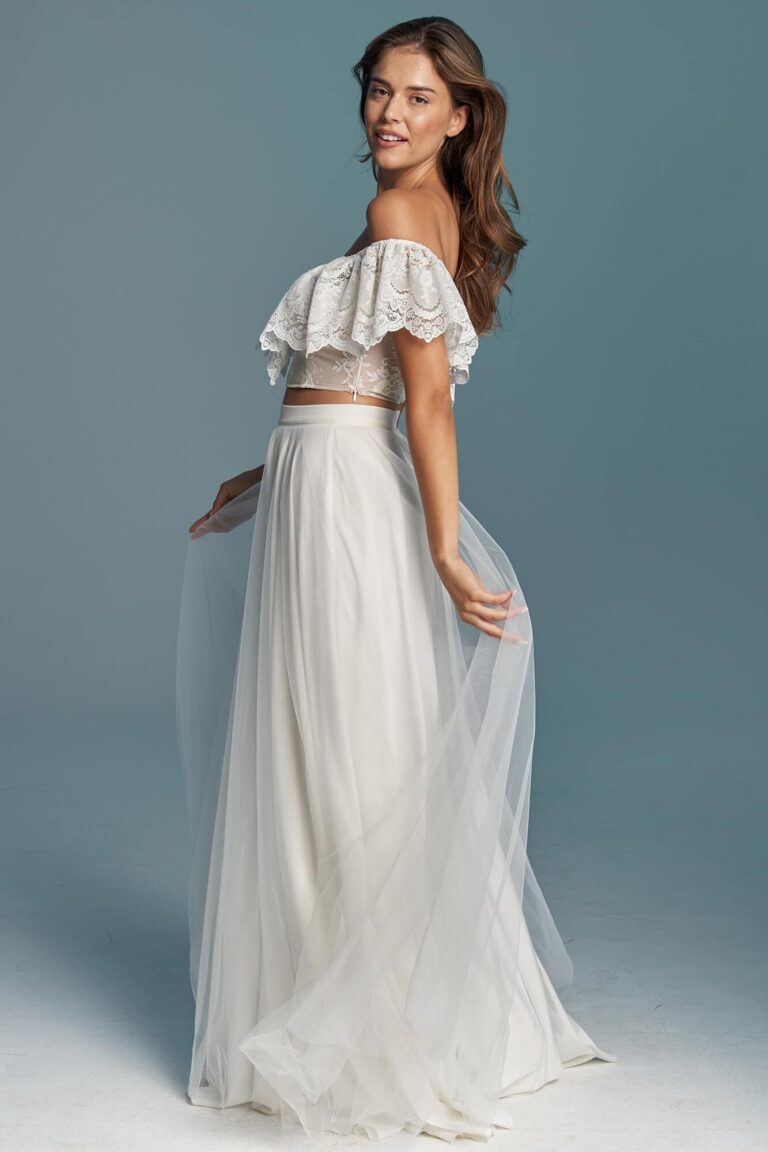 Suknia z odkrytymi ramionami i długim tiulowym dołem.