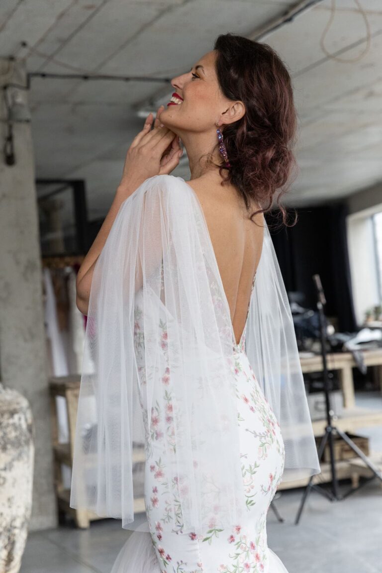 Suknia ślubna z odkrytymi plecami i długimi rękawami z tiulu.