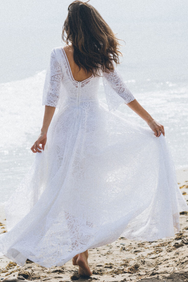 Suknia z odkrytymi plecami i długimi rękawami, widziana z tyłu.