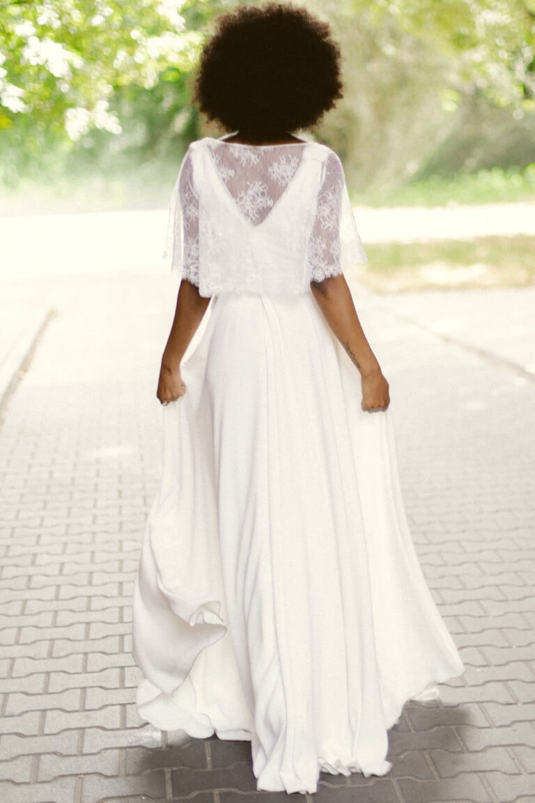 Suknia z odkrytymi plecami oraz długimi, luźnymi rękawami.